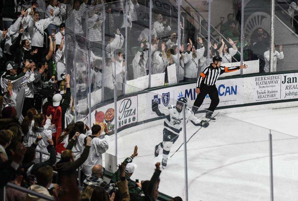 MSU's Tanner Kelly raises his fist as fans cheer after he scored on a penalty shot against Gustavs Davis Grigals of UMass-Lowell, Thursday, Oct. 13, 2022, at Munn Ice Arena in East Lansing. It was his first goal of the season, and ultimately the game-winning shot.