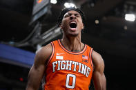 Illinois' Terrence Shannon Jr. (0) reacts after scoring and drawing a foul in overtime during the team's NCAA college basketball game against Texas in the Jimmy V Classic, Tuesday, Dec. 6, 2022, in New York. (AP Photo/John Minchillo)