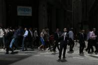 A member of the media reacts as reflected sunlight from the Walkie Talkie tower hits him, in central London September 3, 2013. REUTERS/Stefan Wermuth