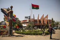 A man walks past the entrance of the headquarters of the FESPACO (Pan-African Film and Television Festival) in Ouagadougou, Burkina Faso, Friday, Feb. 24, 2023. Most film festivals can be counted on to provide entertainment, laced with some introspection. The weeklong FESPACO that opens Saturday in violence-torn Burkina Faso's capital goes beyond that to also offer hope, and a symbol of endurance. (AP Photo/Sophie Garcia)