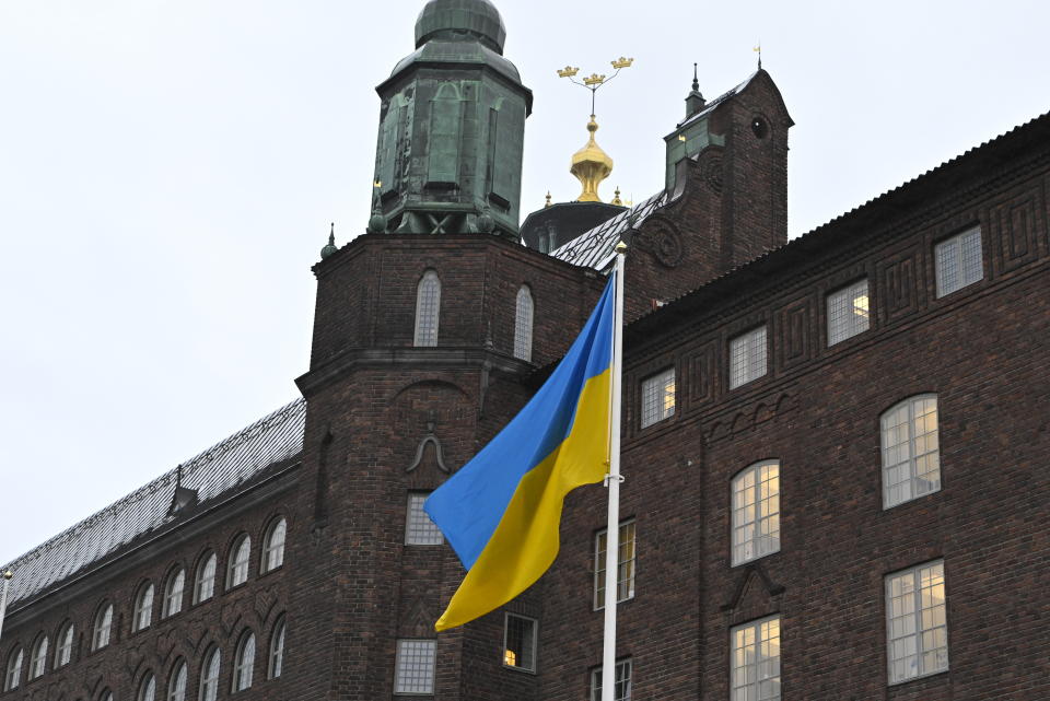The flag of Ukraine waves at Stockholm City Hall, Sweden, Thursday, Feb. 24, 2022. Russia launched a wide-ranging attack on Ukraine on Thursday, hitting cities and bases with airstrikes or shelling, as civilians piled into trains and cars to flee. Ukraine's government said Russian tanks and troops rolled across the border in a “full-scale war” that could rewrite the geopolitical order and whose fallout already reverberated around the world. (Claudio Bresciani/TT via AP)