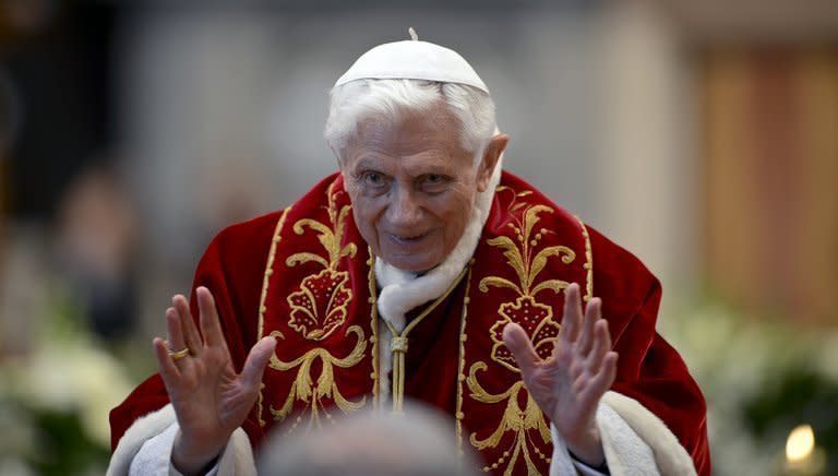 Pope Benedict XVI waves as he leaves the mass at St Peter's Basilica to mark the 900th anniversary of the Order of the Knights of Malta on February 9, 2013 at the Vatican