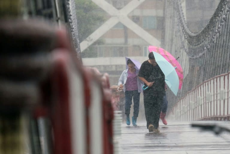 Residents shelter from rain in the New Taipei City, as Typhoon Megi approaches eastern Taiwan, on September 27, 2016