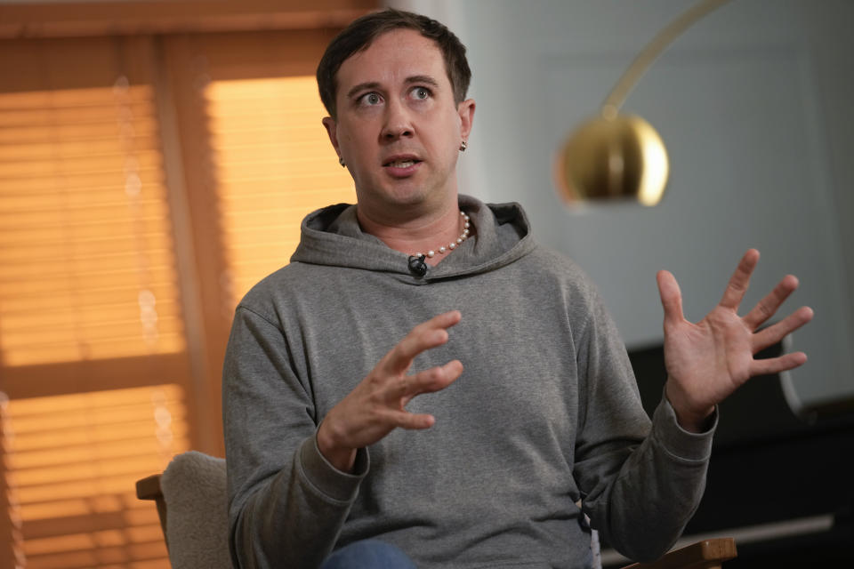 Samuel Schultz talks to reporters at his home, Monday, Oct. 9, 2023, in New York. It took eight years and the burgeoning #MeToo movement to spur them to go public and make a police report, and an additional five years for their attackers to plead guilty. Now, as much as Schultz hopes there’s a reckoning coming in gay and queer communities, too, it feels like they are the one shouldering the blame, not the attackers: for coming forward, for harming the men’s reputations. (AP Photo/Seth Wenig)