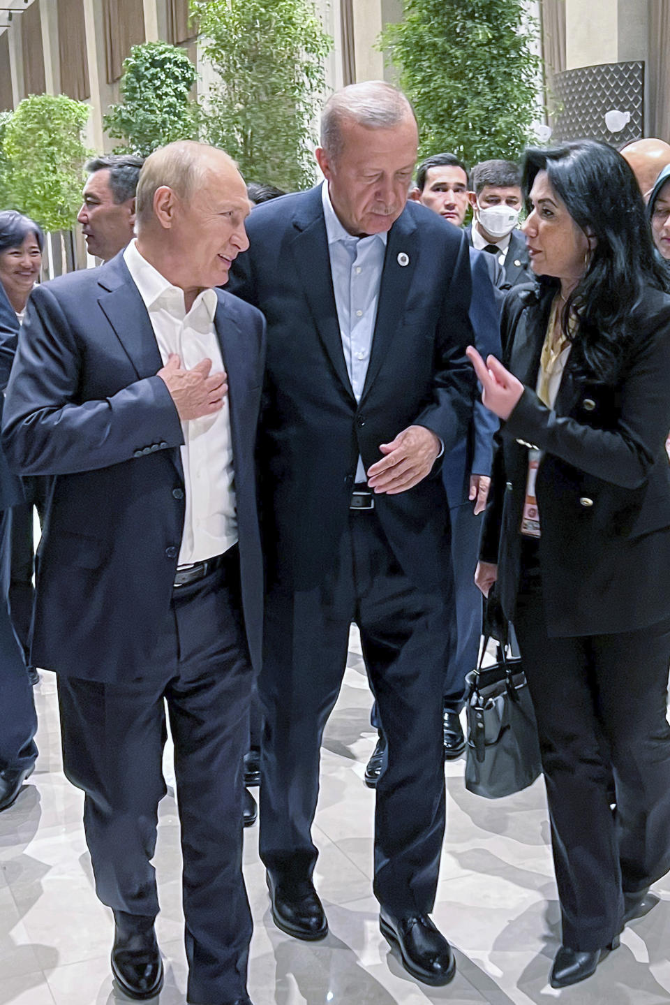 In this photo provided by the Turkish Presidency, Turkey's President Recep Tayyip Erdogan speaks to Russian President Vladimir Putin at the Shanghai Cooperation Organisation (SCO) summit in Samarkand, Uzbekistan, Thursday, Sept. 15, 2022. (Turkish Presidency via AP)