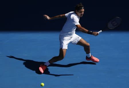 Tennis - Australian Open - Rod Laver Arena, Melbourne, Australia, January 22, 2018. Roger Federer of Switzerland hits a shot against Marton Fucsovics of Hungary. REUTERS/Edgar Su