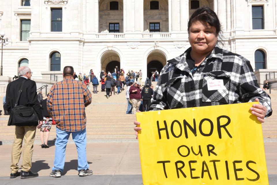 Jean Skinaway Lawrence holds a sign on the steps of the Capitol at the Rise and Repair Lobby Day advocating for Indigenous and climate justice rights on March 12, 2024 in St. Paul, Minn.