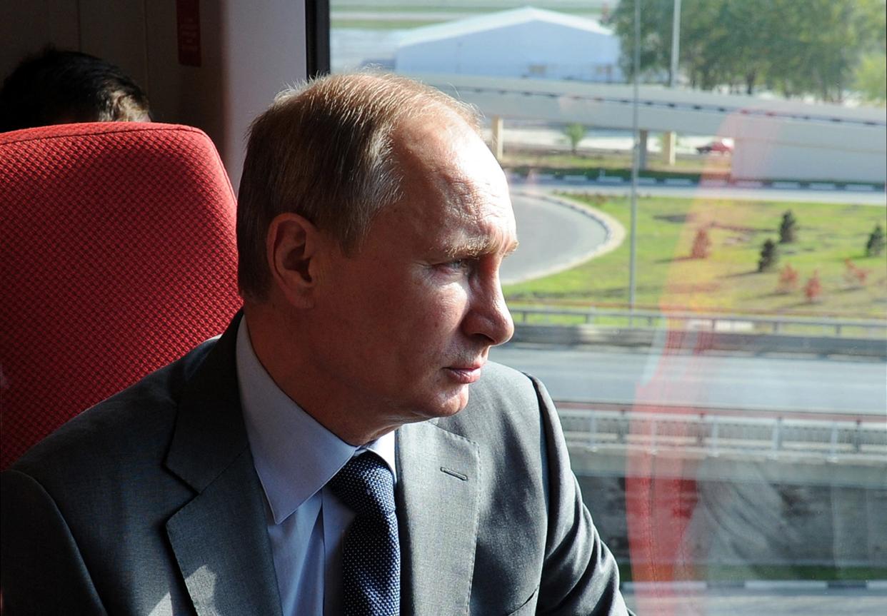 Russian President Vladimir Putin travels by an aeroexpress train in the Russian Black Sea resort of Sochi, on October 28, 2013.