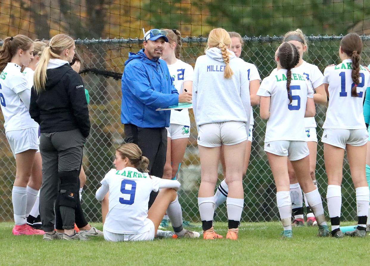Colchester girls soccer coach Jeff Paul speaks to players during a game at Champlain Valley in 2023.