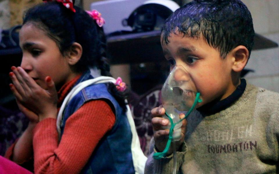 Children receive oxygen through a respirator after the gas attack in Douma, Syria - Syrian Civil Defense White Helmets via AP