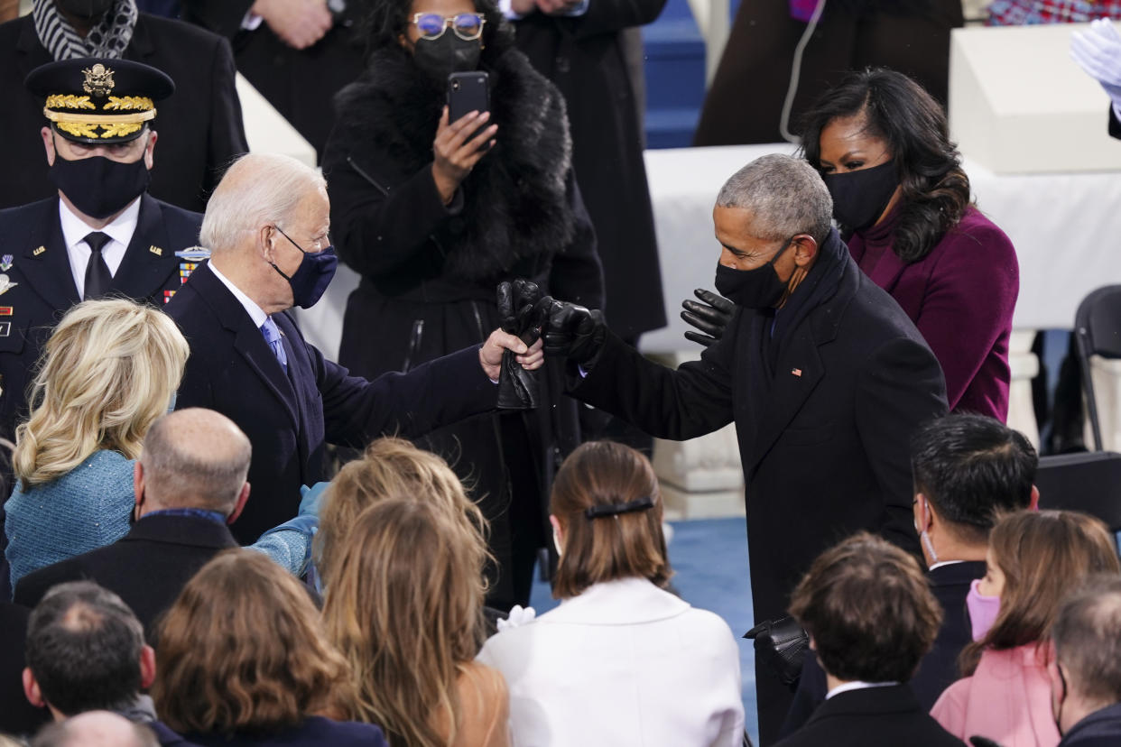 U.S. President-elect Joe Biden, left, greets former U.S. President Barack Obama, right, with a fist bump during the 59th presidential inauguration. (Kevin Dietsch/UPI/Bloomberg via Getty Images)