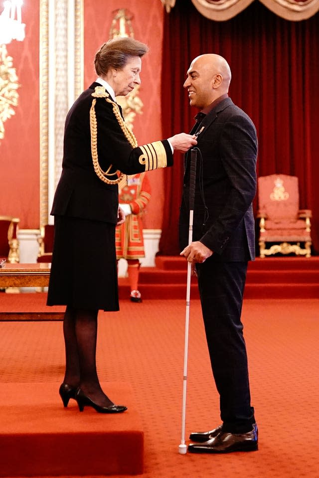 Amar Latif with the Princess Royal at Buckingham Palace