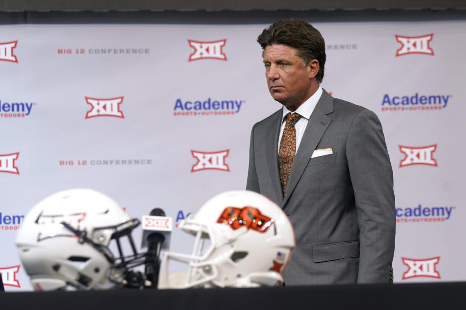 Oklahoma State head coach Mike Gundy walks onto the stage to speak during the NCAA college football Big 12 media days Thursday, July 15, 2021, in Arlington, Texas. (AP Photo/LM Otero)