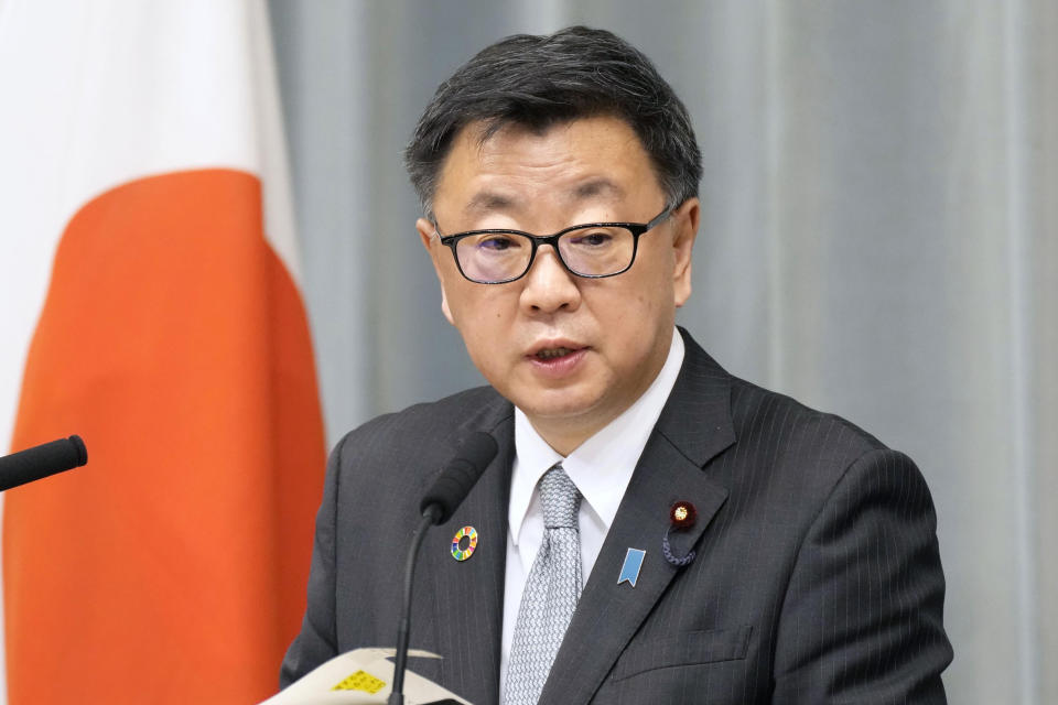 Japan's Chief Cabinet Secretary Hirokazu Matsuno speaks at a news conference in Tokyo, Friday, Dec. 24, 2021. Japan announced Friday it won't send a delegation of ministers to represent the government at the Beijing Games but three Olympic officials will attend, a mixed response to a U.S.-led move to boycott the games to protest China's human rights conditions. (Sadayuki Goto/Kyodo News via AP)