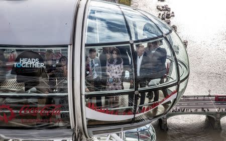 Britain's Princes' William and Harry, and Kate, The Duchess of Cambridge take a ride in a pod of the London Eye with members of the mental health charity "Heads together" on world mental health day in London, Britain October 10, 2016. REUTERS/Richard Pohle/Pool