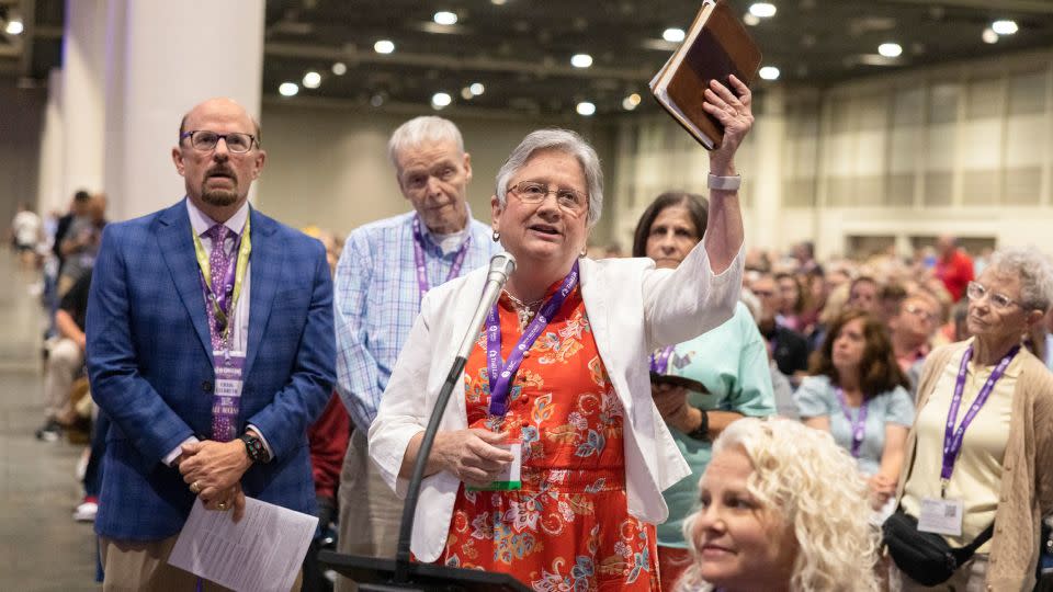 Linda Barnes Popham, the pastor of Fern Creek Baptist Church, holds up a Bible as she appeals the Southern Baptist Convention's decision to expel her church from the denomination in June 2023. - Christiana Botic/The New York Times/Redux