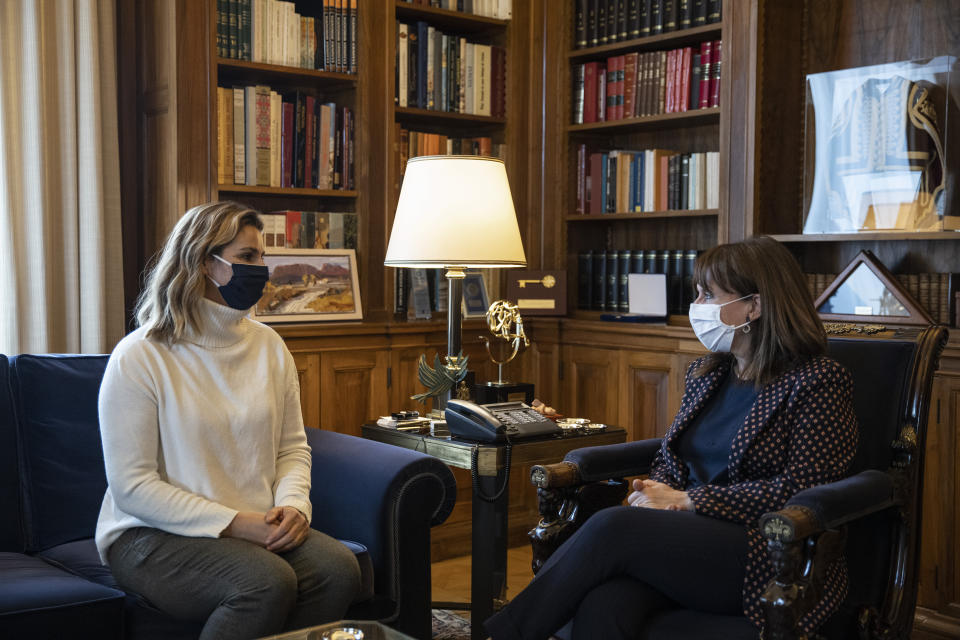 Greek President Katerina Sakellaropoulou meets Olympic sailing champion Sofia Bekatorou, left, at the Presidential Palace in Athens, Monday, Jan. 18, 2021. Bekatorou has accused an unnamed sporting official of sexually assaulting her in 1998 during preparations for the Sydney Games. Bekatorou made the allegation Thursday Jan. 14, 2021 while speaking at an online event organized by the ministry of culture and sport. (Alkis Konstantinidis /Pool via AP)