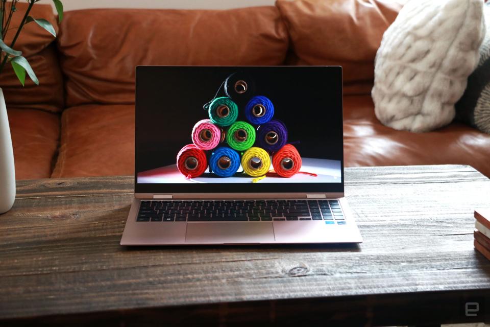 Samsung Galaxy Book Pro 360 review pictures. Front view of the 15-inch Galaxy Book Pro 360 on a table in front of a brown couch.