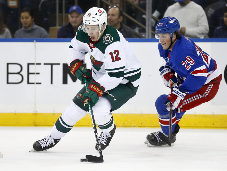 New York Rangers' Dryden Hunt (29) pursues Minnesota Wild's Matt Boldy (12) during the first period of an NHL hockey game Friday, Jan. 28, 2022, in New York. (AP Photo/John Munson)