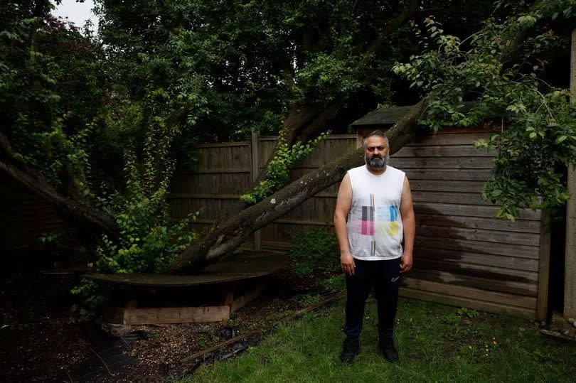 Mr Khan in his garden near the tree