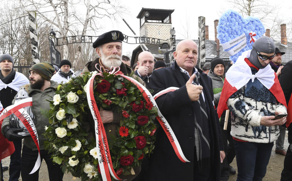 Polish far-right activists enter the former German Nazi death camp Auschwitz-Birkenau, on International Holocaust Remembrance Day in Oswiecim, Poland, Sunday, Jan. 27, 2019.(AP Photo)