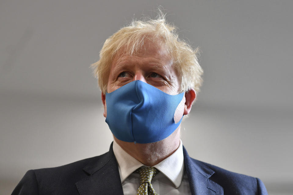 Britain's Prime Minister Boris Johnson, wearing a face mask, visits the headquarters of the London Ambulance Service NHS Trust in London, Monday July 13, 2020. (Ben Stansall/Pool via AP)