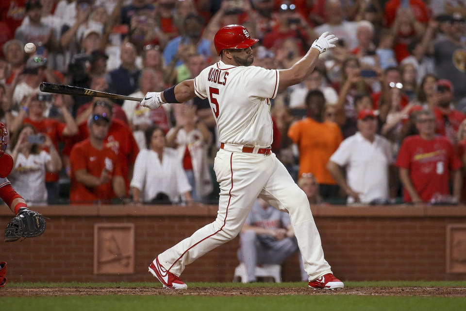 St. Louis Cardinals' Albert Pujols hits a foul ball during the seventh inning in the second baseball game of the team's doubleheader against the Cincinnati Reds on Saturday, Sept. 17, 2022, in St. Louis. (AP Photo/Scott Kane)