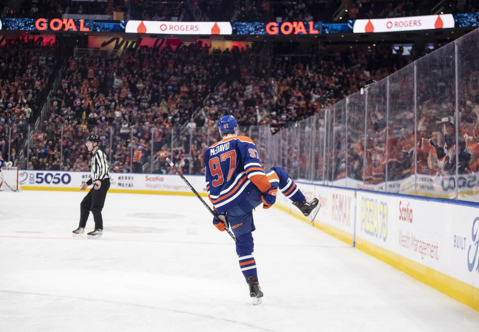 Edmonton Oilers' Connor McDavid (97) celebrates after his 50th goal of the season during second-period NHL hockey game action against the Boston Bruins in Edmonton, Alberta, Monday, Feb. 27, 2023. (Jason Franson/The Canadian Press via AP)