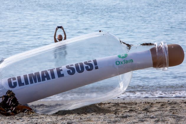 A giant message in a bottle has washed up on the beach from countries ravaged by climate change, on a beach on the 12th of June 2021 near Falmouth, Cornwall, United Kingdom. Oxfam is calling on the G7 countries to commit to cutting emissions further and faster and provide more finance to help the most vulnerable countries respond to the impacts of climate change. (photo by Andrew Aitchison/In Pictures via Getty Images) (Photo: Andrew Aitchison via Getty Images)