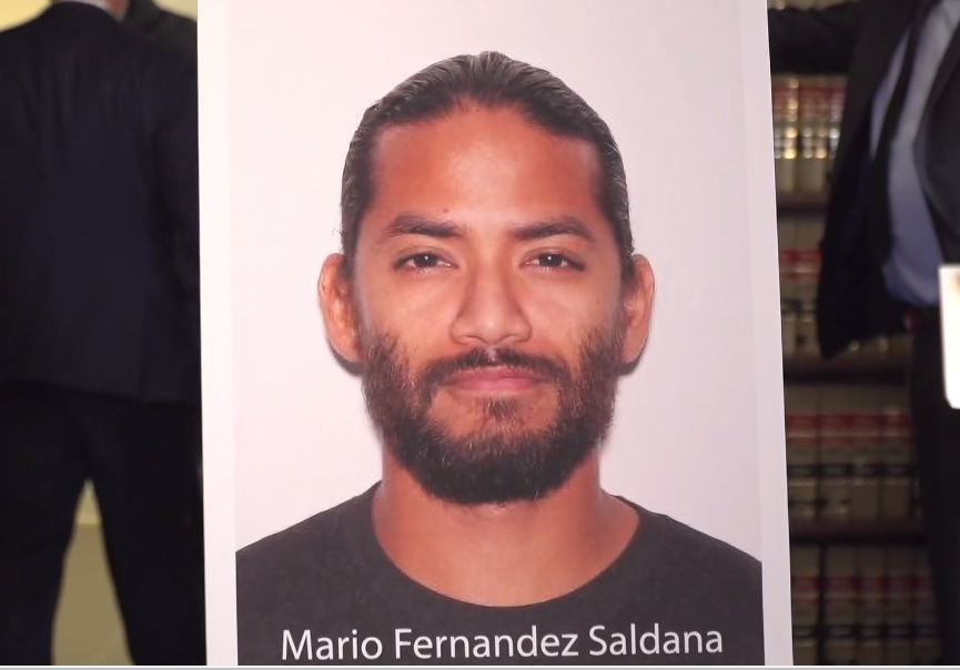 A poster of Mario Fernandez Saldana is displayed during Thursday's news conference announcing his arrest in the shooting death of Jared Bridegan in Jacksonville Beach.
