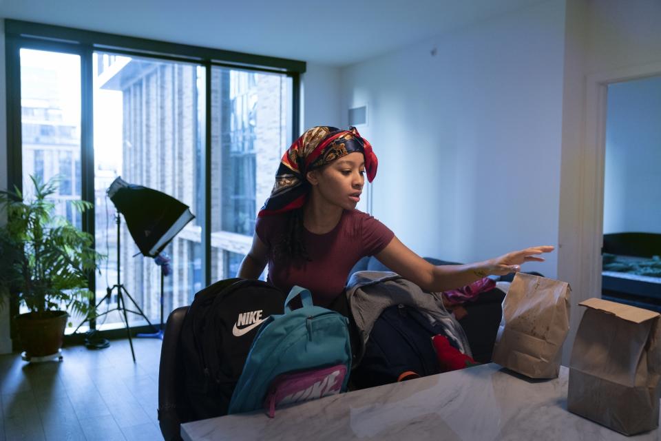 Johnae Strong prepares lunches, backpacks and clothing for her 10-year-old son and 6-year-old daughter as they ready for school and work Friday, Feb. 10, 2023, in Chicago. (AP Photo/Erin Hooley)