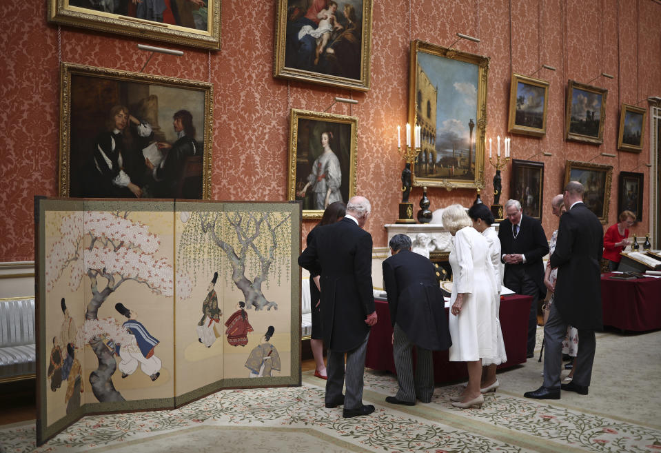 Britain's King Charles III, Japan's Emperor Naruhito, Britain's Queen Camilla and Japan's Empress Masako view a display of Japanese items from the Royal Collection, in the Picture Gallery at Buckingham Palace in London, Tuesday, June 25, 2024, on the first day of their three-day State Visit to Britain. The Japanese royal couple arrived in Britain for a three-day state visit hosted by King Charles III. (Henry Nicholls/pool photo via AP)