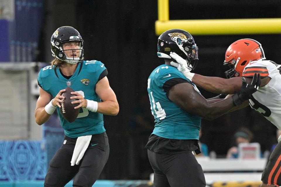 Jacksonville Jaguars quarterback Trevor Lawrence, left, looks for a receiver against the Cleveland Browns during a preseason game Aug. 14, 2021, in Jacksonville, Fla.