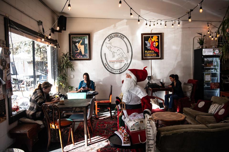 Customers hangout inside at The Fox Den coffee shop in Fort Collins, Colo., on Monday, Nov. 13, 2023.