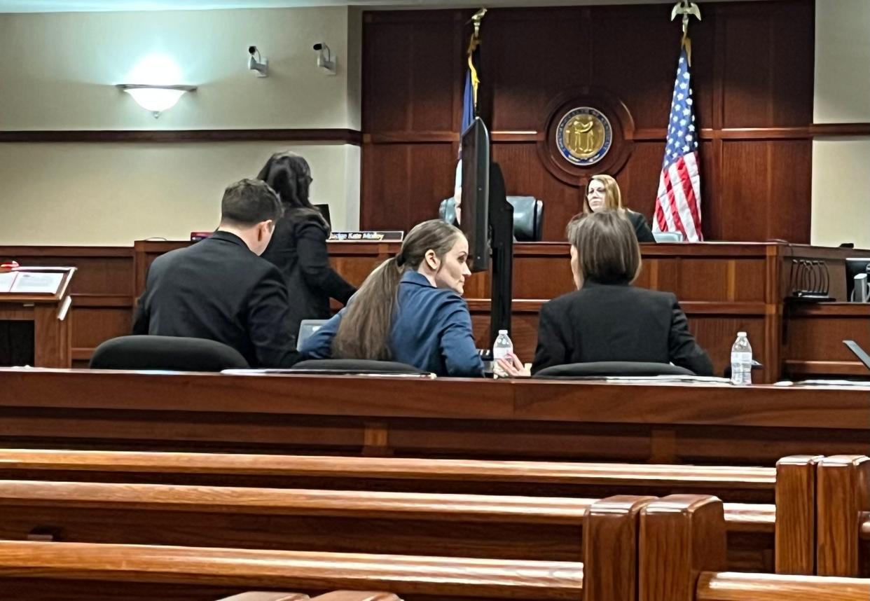 Lauren Baker (center) sits in court April 19, 2023 on trial for murder in connection with her 2-year-old son’s overdose death.