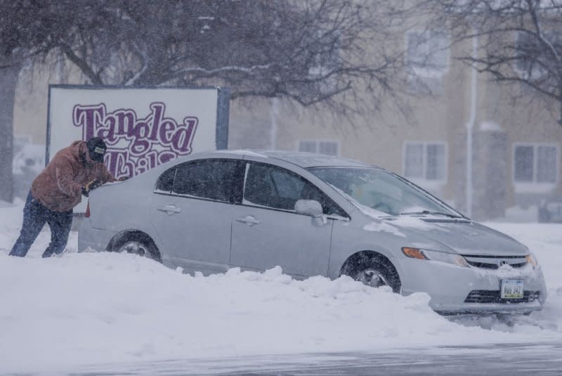 A man pushes a car stuck in the snow as a winter storm drops temperatures in Altoona, Iowa, on Friday. Forecasters said strong winds could blow snow to create blizzard-like conditions and slick roads through Saturday.
Photo by Tannen Maury/UPI