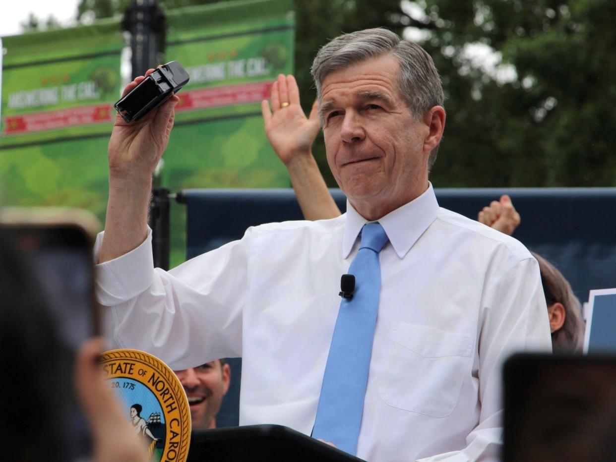 North Carolina Democratic Gov. Roy Cooper affixes his veto stamp to a bill banning nearly all abortions after 12 weeks of pregnancy at a public rally Saturday, May 13, 2023, in Raleigh, North Carolina.