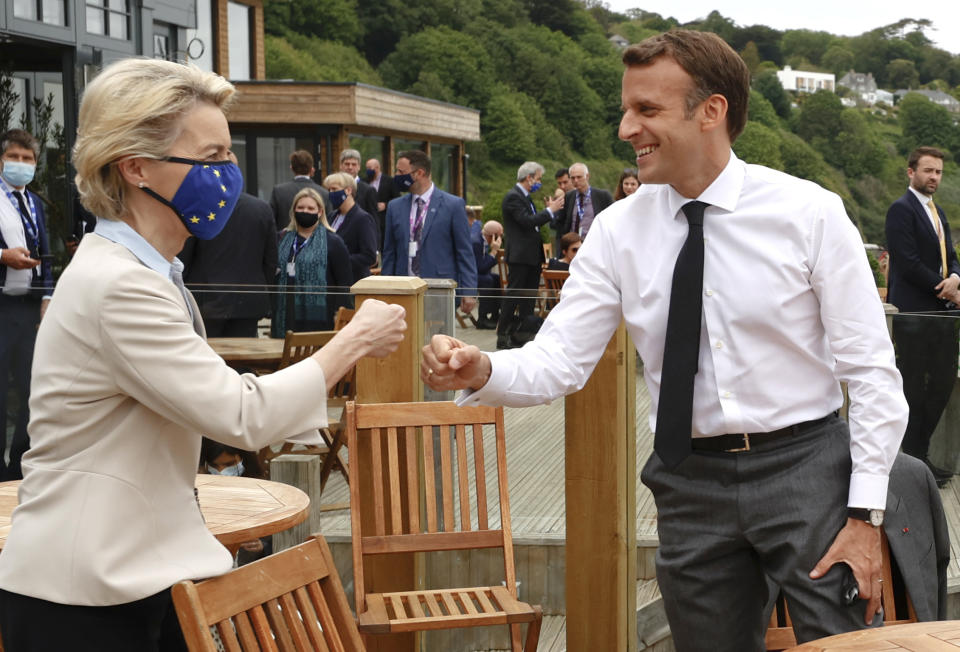 European Commission President Ursula von der Leyen, left, greets French President Emmanuel Macron with a fist bump during an EU coordination meeting prior to the G7 meeting at the Carbis Bay Hotel in Carbis Bay, St. Ives, Cornwall, England, Friday, June 11, 2021. Leaders of the G7 begin their first of three days of meetings on Friday, in which they will discuss COVID-19, climate, foreign policy and the economy. (Phil Noble, Pool via AP)