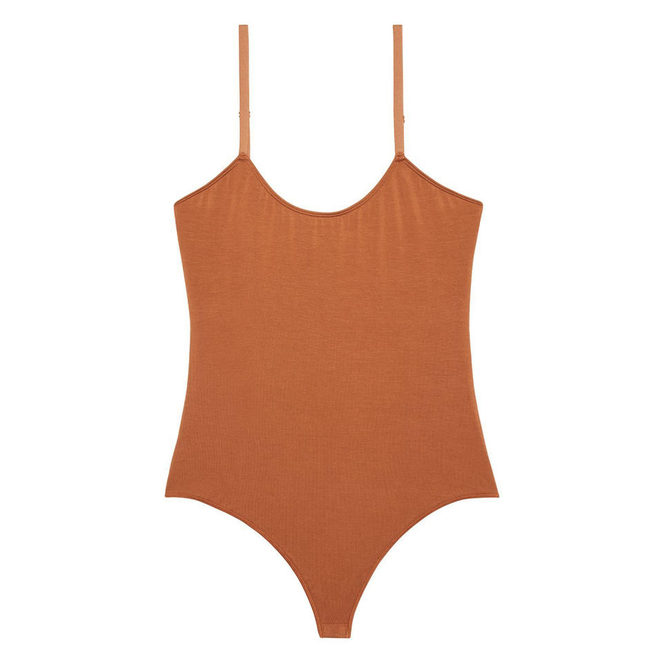 <p>This thong one-piece will give you a smooth, tucked-in look. </p> <p><strong>Buy It!</strong> Bodysuit, $78; <a href="https://www.kitundergarments.com/collections/body/products/basic-strappy-body-suit?variant=22116803444825" rel="nofollow noopener" target="_blank" data-ylk="slk:kitundergarments.com;elm:context_link;itc:0;sec:content-canvas" class="link ">kitundergarments.com</a></p>