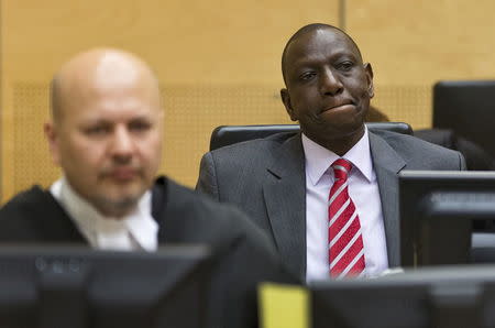 Kenya's Deputy President William Ruto (R) reacts as he sits in the courtroom before his trial at the International Criminal Court (ICC) in The Hague in this September 10, 2013 file photo. REUTERS/Michael Kooren/Files