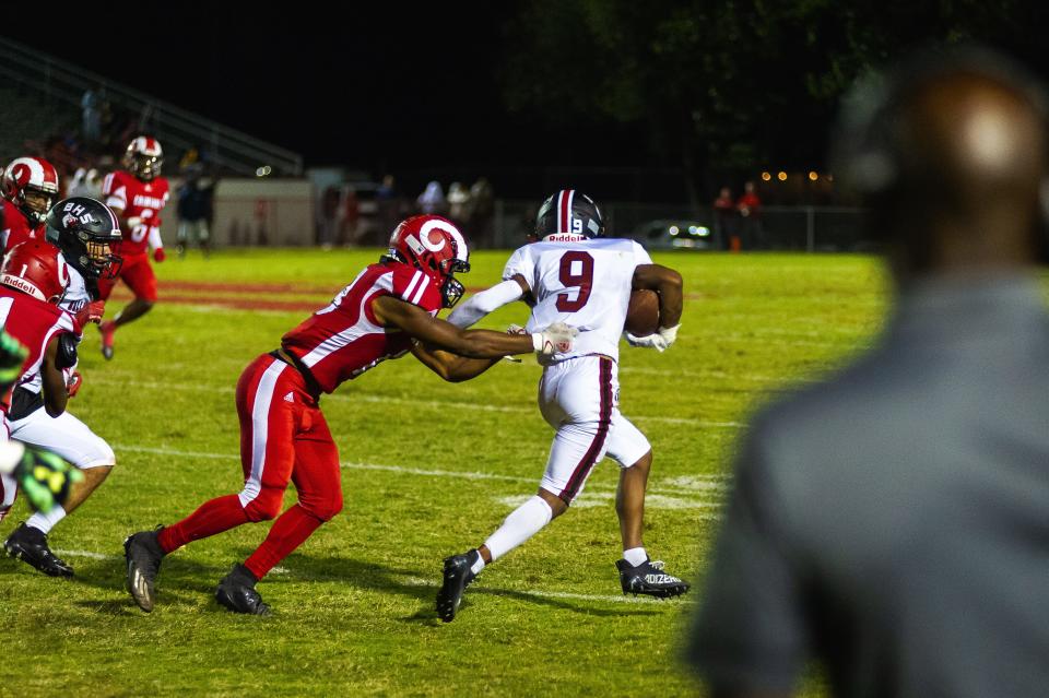 Ballard High School's Kameron Horton breaks free from a Manual defender during a football game Friday, Sept. 23, 2022, in Louisville, Ky. The Bruins fell to the Crimsons 21-0.