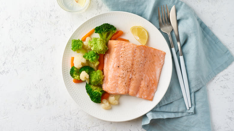 Salmon and veggies on a white plate