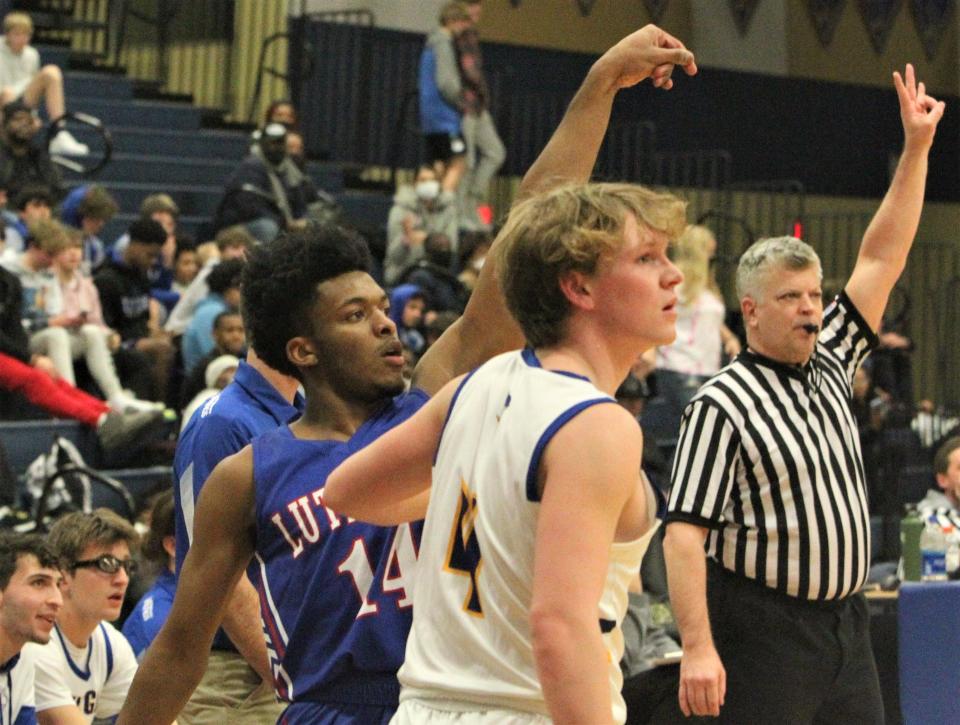 Wisconsin Lutheran's Jordan Glenn (14) and New Berlin West's Joshua Riegler (4) watch Glenn's three-point shot during the teams' game on Friday, Jan. 28, 2022, at New Berlin West High School.