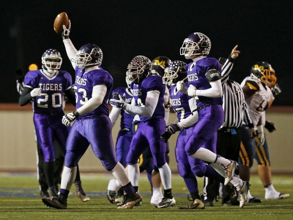 Pickerington Central's DaVon Hamilton holds up the ball after recovering a fumble during a regional semifinal against Cincinnati Moeller in 2014. Hamilton went on to have a standout career at Ohio State before being selected by the Jacksonville Jaguars in the NFL draft.