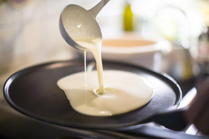 Pouring pancake batter into a skillet