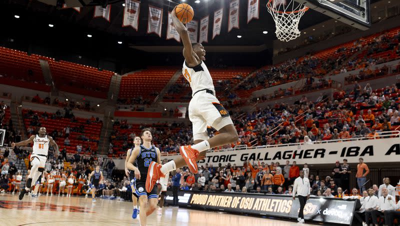 Oklahoma State center Brandon Garrison (23) goes up for a dunk in the second half of the NCAA college basketball game against BYU, Saturday, Feb. 17, 2024, in Stillwater, Okla. (AP Photo/Mitch Alcala)
