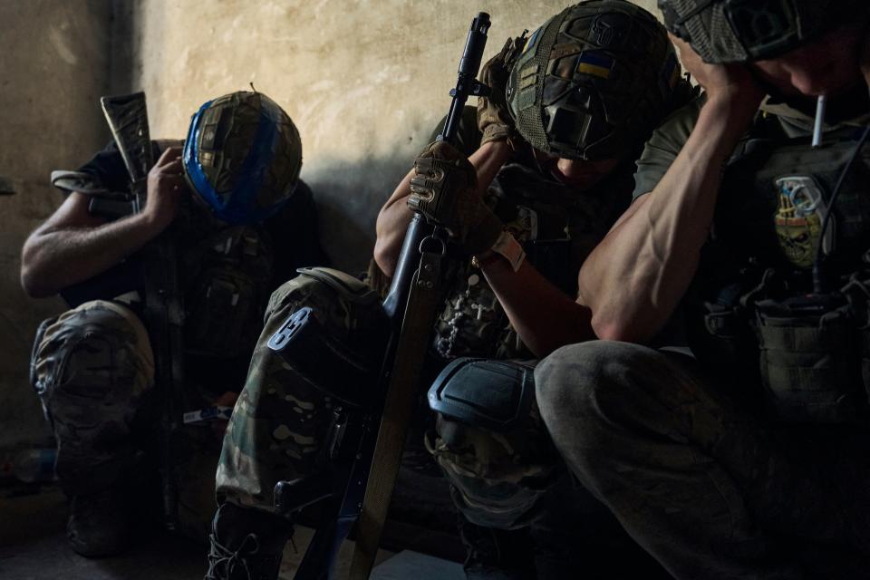 krainian soldiers cover their ears to protect from the Russian tank shelling in a shelter on the frontline in the Zaporizhzhia region (AP)