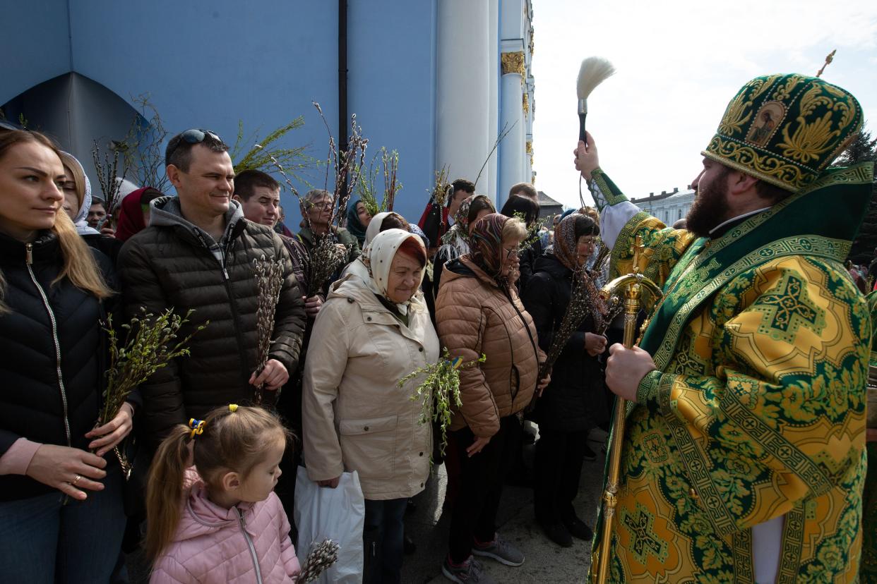 Orthodox priests bless believers and consecrate willow branches with holy water on Palm Sunday near St. Michael's Church in Kyiv, Ukraine (Anadolu Agency via Getty Images)