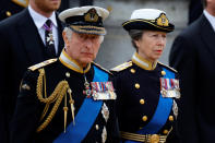 <p>King Charles III and his sister Princess Anne in procession behind the Queen's coffin as it is taken to Westminster Abbey. (AFP via Getty Images)</p> 