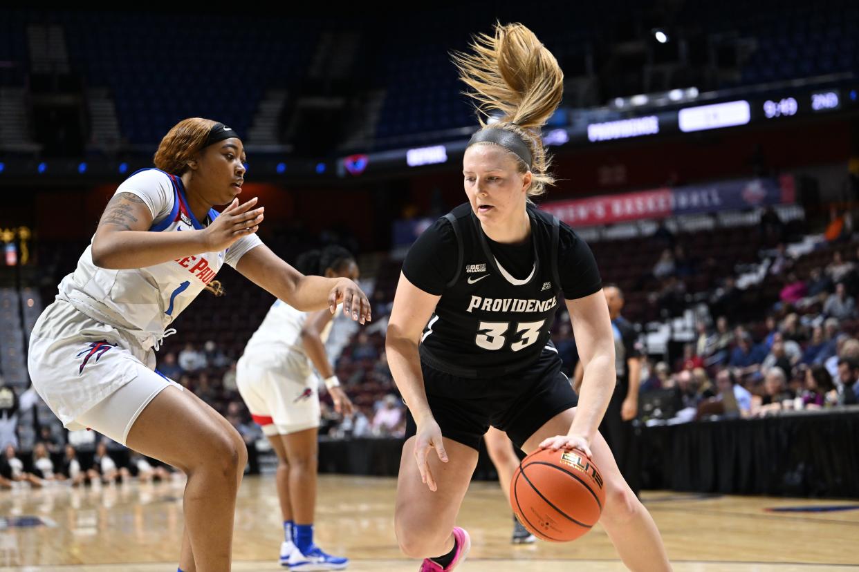 Providence College junior Emily Archibald, right, handles the ball last season during a Big East game against DePaul.